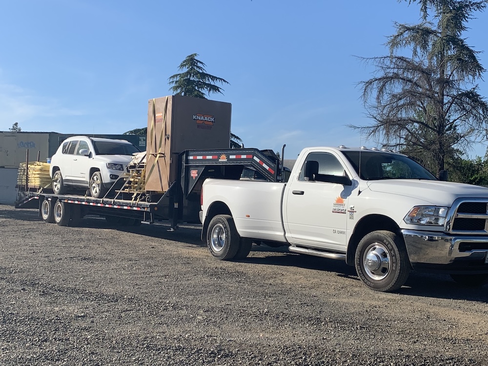 Hotshot truck with assorted materials loaded on the trailer